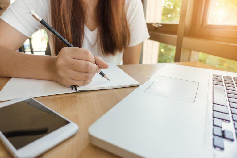 Student taking notes during a tutorial