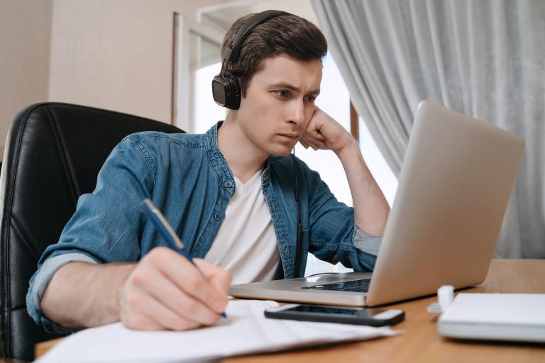 Postgraduate student working on laptop