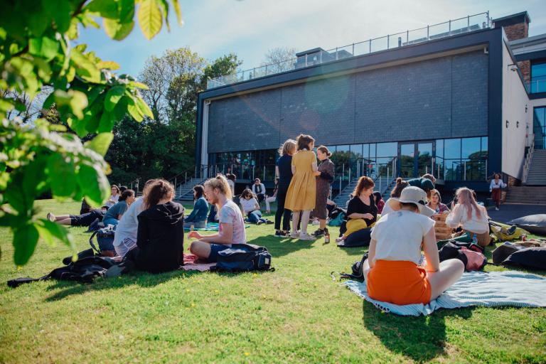 groups of people having a picnic in the sun