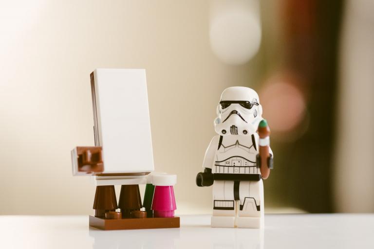 Lego stormtrooper standing in front of a whiteboard.