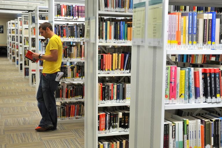 Student reading book in Library