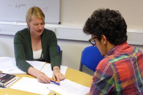 Language tutor working with a student
