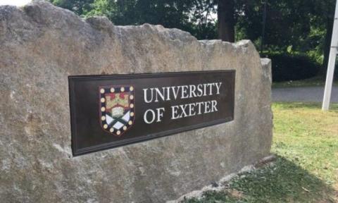 Granite boulder with University of Exeter sign and coat of arms