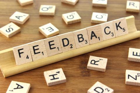 The word feedback written in scrabble tiles